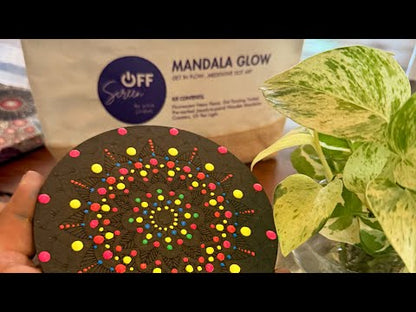 "Hand applying UV acrylic paint dots onto a pre-marked wooden mandala using a precision dotting tool"